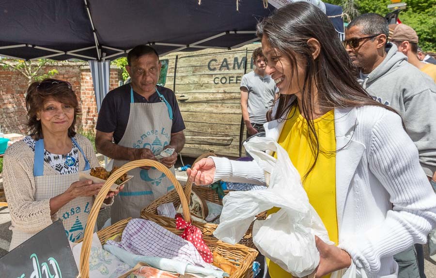 We have several local Indian restaurants in the town and the Samosa Lady with her shop and restaurant has in a short time established a name for herself. Here Jennifer is shopping from her stand being served by the mother of the Samosa Lady.