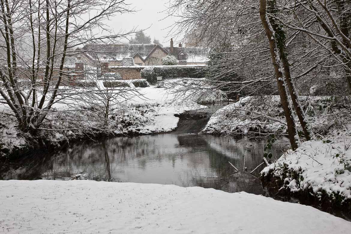 Knightstone in snow photographed from the pond in the park.