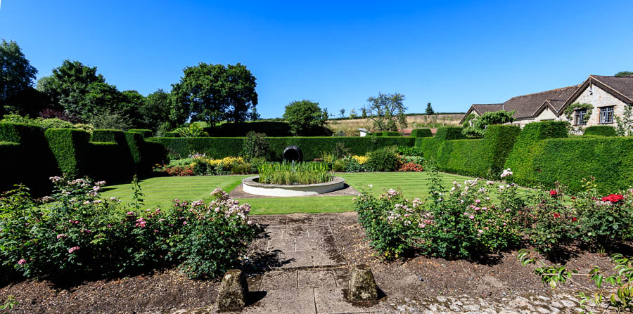 The Rose Garden with the now quite dry wildflower meadow in the background