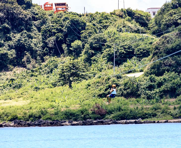 Mikee is ziplining in Pagudpud crossing the Blue Lagoon