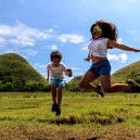 Another jump shot in front of the chocolate hills