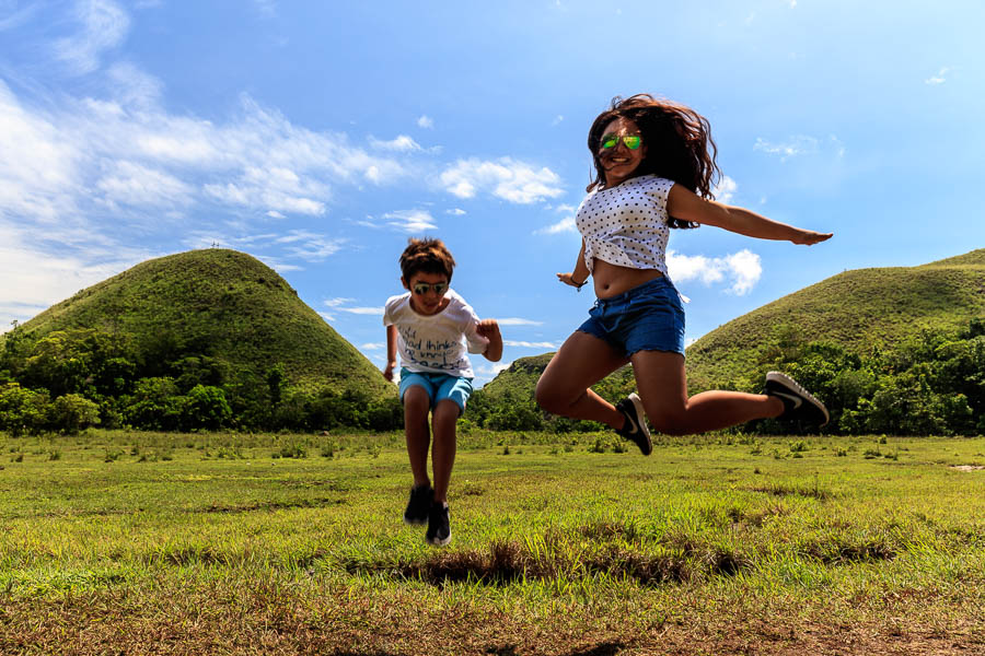 Another jump shot in front of the chocolate hills