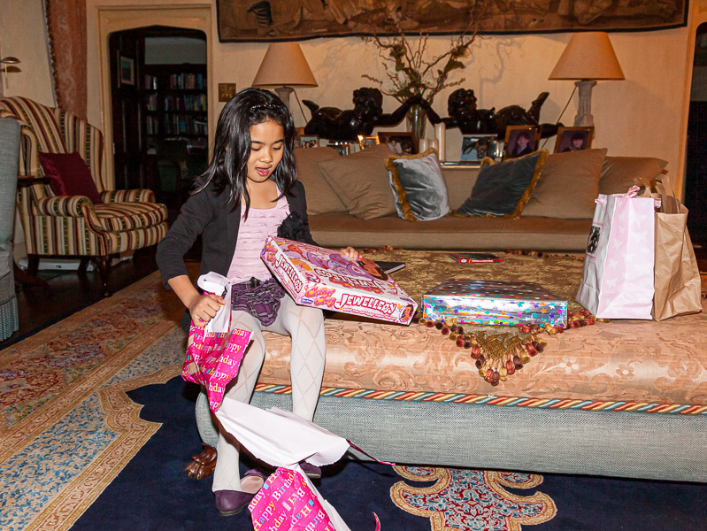 Mikee opening her presents after the party