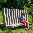 Eric sitting on the bench looking out over the meadow