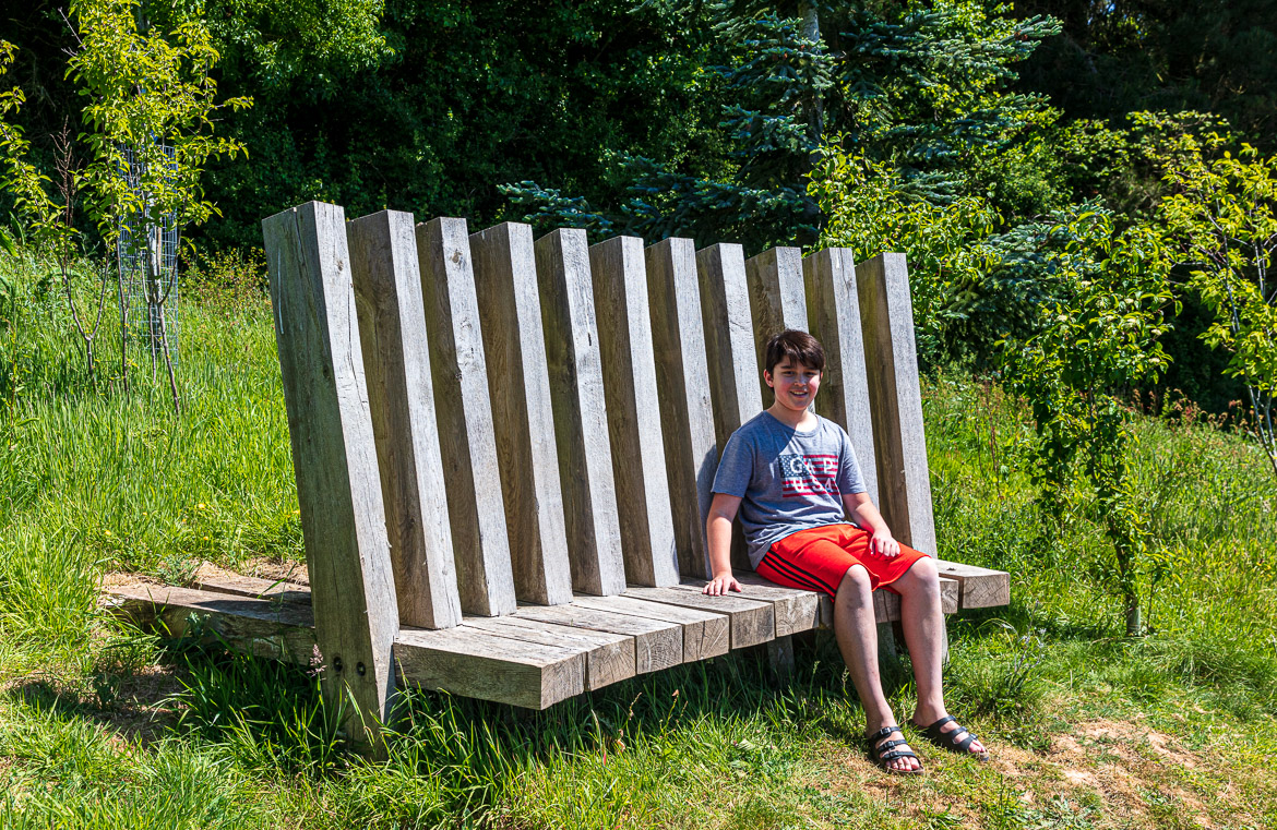 Eric sitting on the bench looking out over the meadow