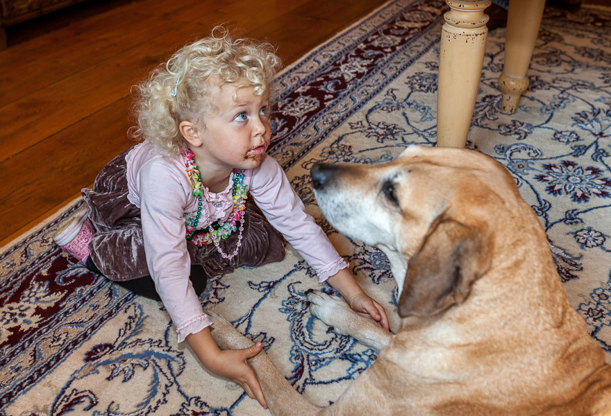 Candice, with chocolate around her mouth, is playing with Nalah