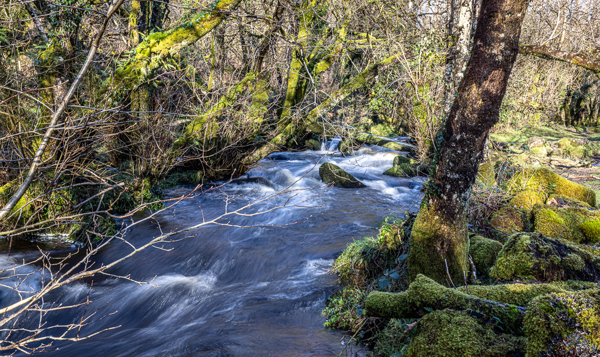 The Clapper Bridge is difficult to see but is at the far end of the stream