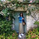 Jennifer showing the size of the doorway into one of the cottages.