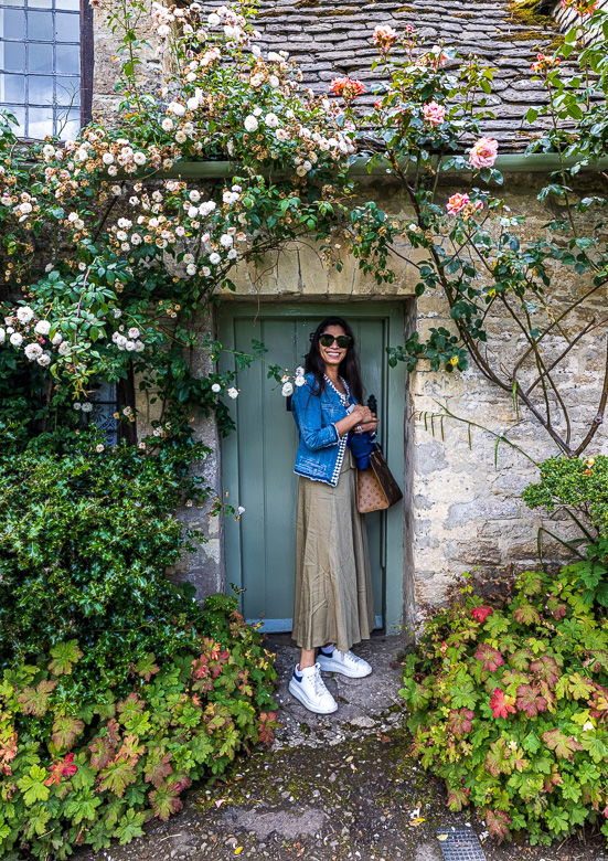 Jennifer showing the size of the doorway into one of the cottages.