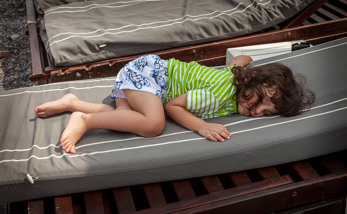 Eric fell asleep on a sunbed, when we anchored at an island