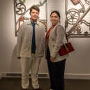 Eric and Mikee in front of artwork by Bob Dylan