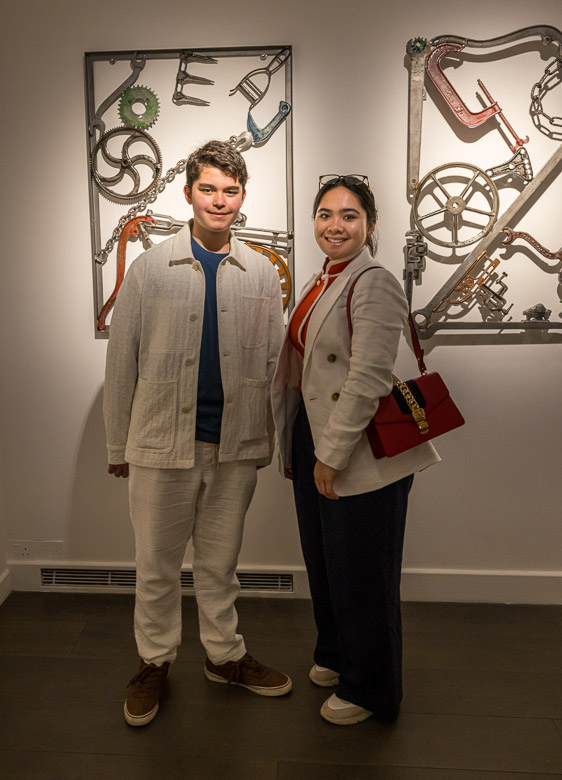 Eric and Mikee in front of artwork by Bob Dylan
